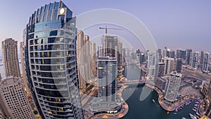 Beautiful aerial top view day to night transition timelapse of Dubai Marina canal