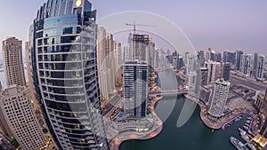 Beautiful aerial top view day to night transition timelapse of Dubai Marina canal