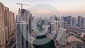 Beautiful aerial top view day to night transition timelapse of Dubai Marina canal