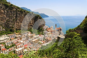 Beautiful aerial view of Atrani village between green branches and cliff rocks, Amalfi Coast, Italy.