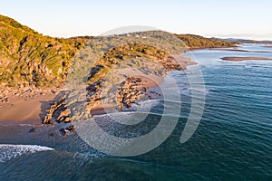 Beautiful aerial view of a beach escape with nice beach, rocks and warm gentle waves photo