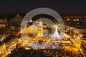 Beautiful aerial view of decorated and illuminated Christmas tree on the Cathedral Square at night in Vilnius, Lithuania