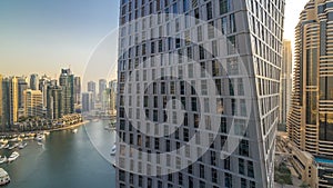 Beautiful aerial view of Dubai Marina promenade and canal with floating yachts and boats before sunset in Dubai, UAE.