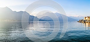 Beautiful aerial view of the famous Como Lake on sunny summer day. Clouds reflecting in calm waters of the lake with Alp mountains