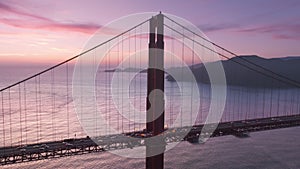 Beautiful aerial view of Golden Gate Bridge at epic rose purple sky background