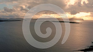 Beautiful aerial view of Isle of Skye coast at sunset with godrays