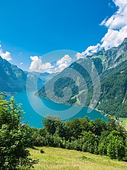 Beautiful aerial view of Kloental lake Kloenthalsee and valley, Swiss Alps, on a sunny summer day with blue sky cloud, Canton of