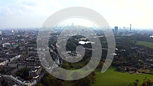 Beautiful aerial view of London with many green parks and city skyscrapers