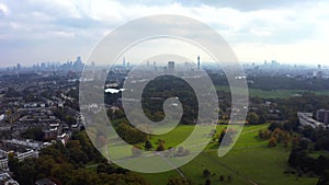 Beautiful aerial view of London with many green parks and city skyscrapers