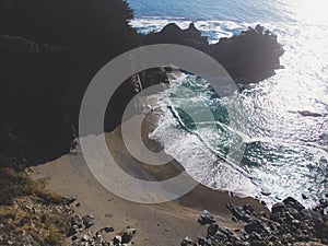 Beautiful aerial view of Mcway Falls with Julia Pfeiffer Beach and Pacific Ocean, Big Sur, Monterey County, California, United