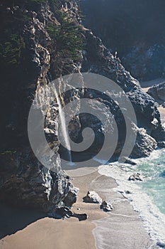 Beautiful aerial view of Mcway Falls with Julia Pfeiffer Beach and Pacific Ocean, Big Sur, Monterey County, California, United