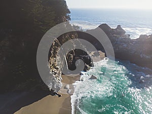 Beautiful aerial view of Mcway Falls with Julia Pfeiffer Beach and Pacific Ocean, Big Sur, Monterey County, California, United