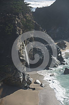 Beautiful aerial view of Mcway Falls with Julia Pfeiffer Beach and Pacific Ocean, Big Sur, Monterey County, California, United