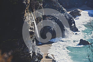 Beautiful aerial view of Mcway Falls with Julia Pfeiffer Beach and Pacific Ocean, Big Sur, Monterey County, California, United