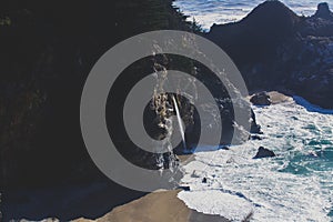 Beautiful aerial view of Mcway Falls with Julia Pfeiffer Beach and Pacific Ocean, Big Sur, Monterey County, California, United