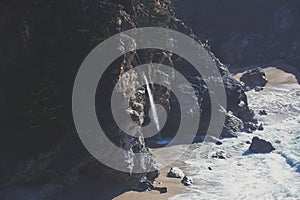 Beautiful aerial view of Mcway Falls with Julia Pfeiffer Beach and Pacific Ocean, Big Sur, Monterey County, California, United