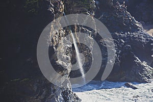 Beautiful aerial view of Mcway Falls with Julia Pfeiffer Beach and Pacific Ocean, Big Sur, Monterey County, California, United