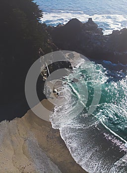 Beautiful aerial view of Mcway Falls with Julia Pfeiffer Beach and Pacific Ocean, Big Sur, Monterey County, California, United