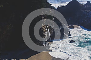 Beautiful aerial view of Mcway Falls with Julia Pfeiffer Beach and Pacific Ocean, Big Sur, Monterey County, California, United photo