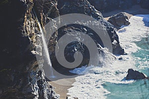 Beautiful aerial view of Mcway Falls with Julia Pfeiffer Beach and Pacific Ocean, Big Sur, Monterey County, California, United