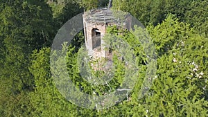 Beautiful aerial view of an Orthodox Church and surrounding forest. Clip. Top view of ruined and abandoned chapel
