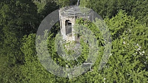 Beautiful aerial view of an Orthodox Church and surrounding forest. Clip. Top view of ruined and abandoned chapel