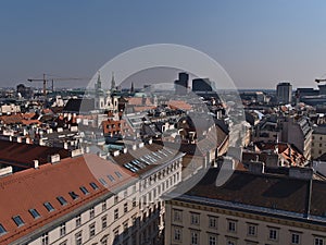 Beautiful aerial view over the historic city center of Vienna, Austria with narrow alley between old buildings.