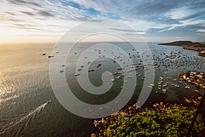 Beautiful aerial view over the sea and fisher boats at sunset in vietnam