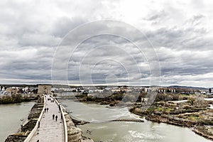 Beautiful aerial view of the river Guadalquivir river and the Roman bridge of Cordoba with the city in the background