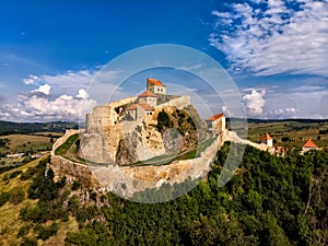 Beautiful aerial view of the Rupea Stronghold on a blue sky with white clouds