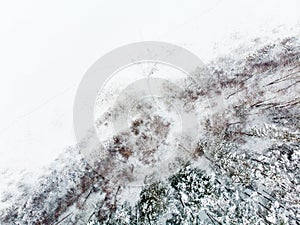 Beautiful aerial view of snow covered pine forests aroung Gela lake. Rime ice and hoar frost covering trees. Scenic landscape near