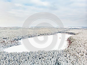 Beautiful aerial view of snow covered pine forests aroung Gela lake. Rime ice and hoar frost covering trees. Scenic landscape near