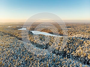 Beautiful aerial view of snow covered pine forests. Rime ice and hoar frost covering trees. Winter landscape near Vilnius,