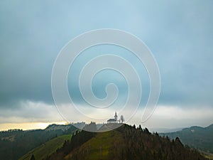 Beautiful aerial view of a st. Jakob church near Medvode, Slovenia on a hill