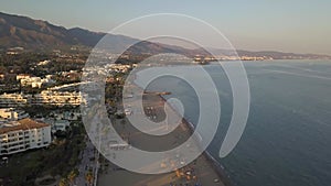 Beautiful aerial view of sunset over Puerto Banus Bay, Marbella , Spain. Golden hour colours.