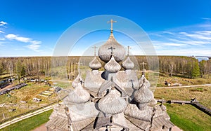 Beautiful Aerial view to traditional Russian village with orthodox wooden chapel and bell tower in Bogoslovka manor
