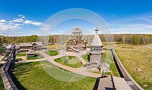 Beautiful Aerial view to traditional Russian village with orthodox wooden chapel and bell tower in Bogoslovka manor