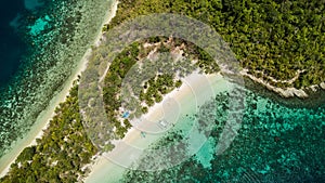 Beautiful aerial view of a tropical isolated island in Port Barton, Palawan, The Philippines