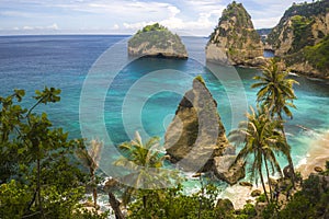 Beautiful aerial view of tropical paradise beach and rock cliff with amazing turquoise sea water and palm trees in Summer holidays