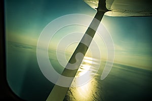 A beautiful aero landscape of a Baltic sea looking out of a small plane window under the wing. Riga, Latvia, Europe in summer. Aut