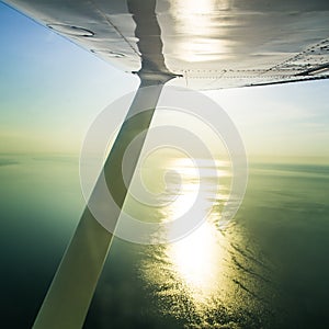 A beautiful aero landscape of a Baltic sea looking out of a small plane window under the wing. Riga, Latvia, Europe in summer. Aut