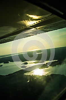 A beautiful aero landscape of a Baltic sea looking out of a small plane window under the wing. Riga, Latvia, Europe in summer. Aut