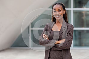 Beautiful african american business woman portrait, arms folded, confident happy CEO