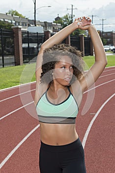 Beautiful African-American female fitness model on outdoor track