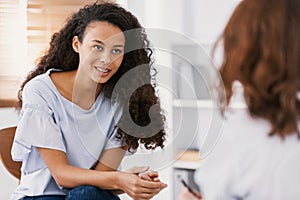 Beautiful african american girl during meeting with professional counselor photo