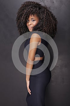 Beautiful african american girl posing in elegant dress.