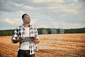 Beautiful African American man is in the agricultural field