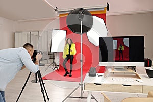 Beautiful African American model posing for professional photographer in studio