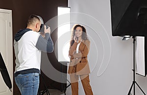 Beautiful African American model posing for professional photographer in studio