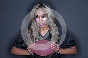 Beautiful African American Model Wearing A Football Helmet And Holding A Football